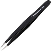 Tweezerman point tweezer closeup with precision tips for fine hair removal.