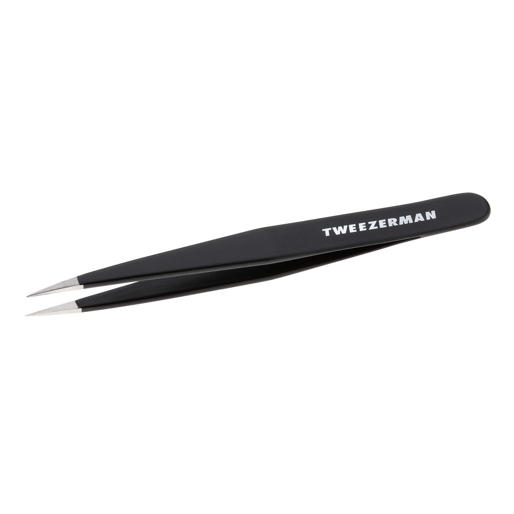 Tweezerman stainless steel point tweezer close-up with precision tips for fine brow hair removal.