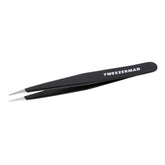 Tweezerman stainless steel point tweezer close-up with precision tips for fine brow hair removal.