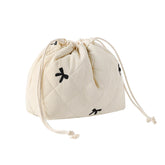 The uekeboag cotton quilted drawstring makeup bag in beige bows keeps cosmetics organized on the go.