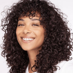 Umberto Giannini Curl Whip mousse bottle demonstrates lightweight hold for bouncy curls