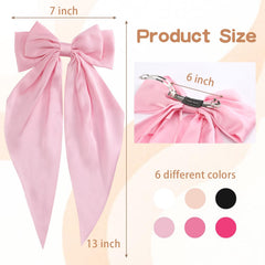 Unbednigt pink satin bow clip close-up showing lush texture and metallic clasp.