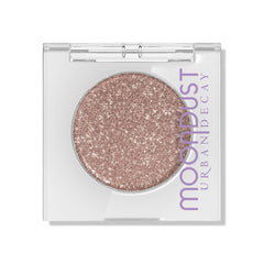 Urban Decay Moondust Space Cowboy swatch on arm reveals champagne-gold sparkle with lasting shine.
