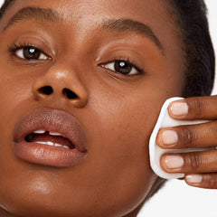 Versed Baby Cheeks toner cotton pad closeup showing milk-like texture removing makeup traces gently
