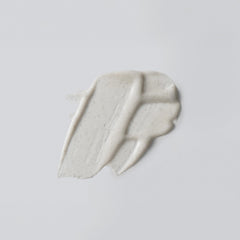 Versed Buff It Out in-shower application shows massaging action for exfoliating and softening skin.