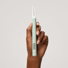 Versed dermaplaning tool angled for use on the face to enhance control.