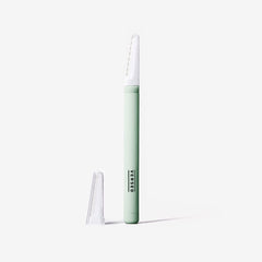 Versed dermaplaning tool blade exposed for close, safe shaving on the skin.