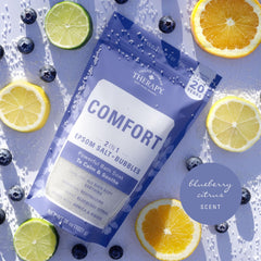 Village Naturals Therapy Comfort Foaming Bath Soak bubbles scene emphasizes spa-like relaxation after long day.