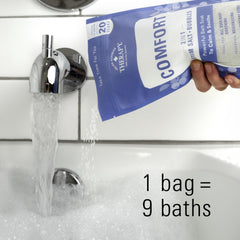 Village Naturals Therapy Comfort Foaming Bath Soak tub scene conveys soothing weekend self-care ritual.
