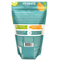 Village Naturals Therapy Hydrate Foaming Bath Soak being poured under warm water