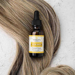 Vitality Extracts Hair Envy argan oil droplets on hair strand for smooth appearance