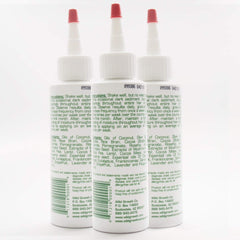 Wild Growth hair oil application close-up shows multi-drop use for longer, softer hair.