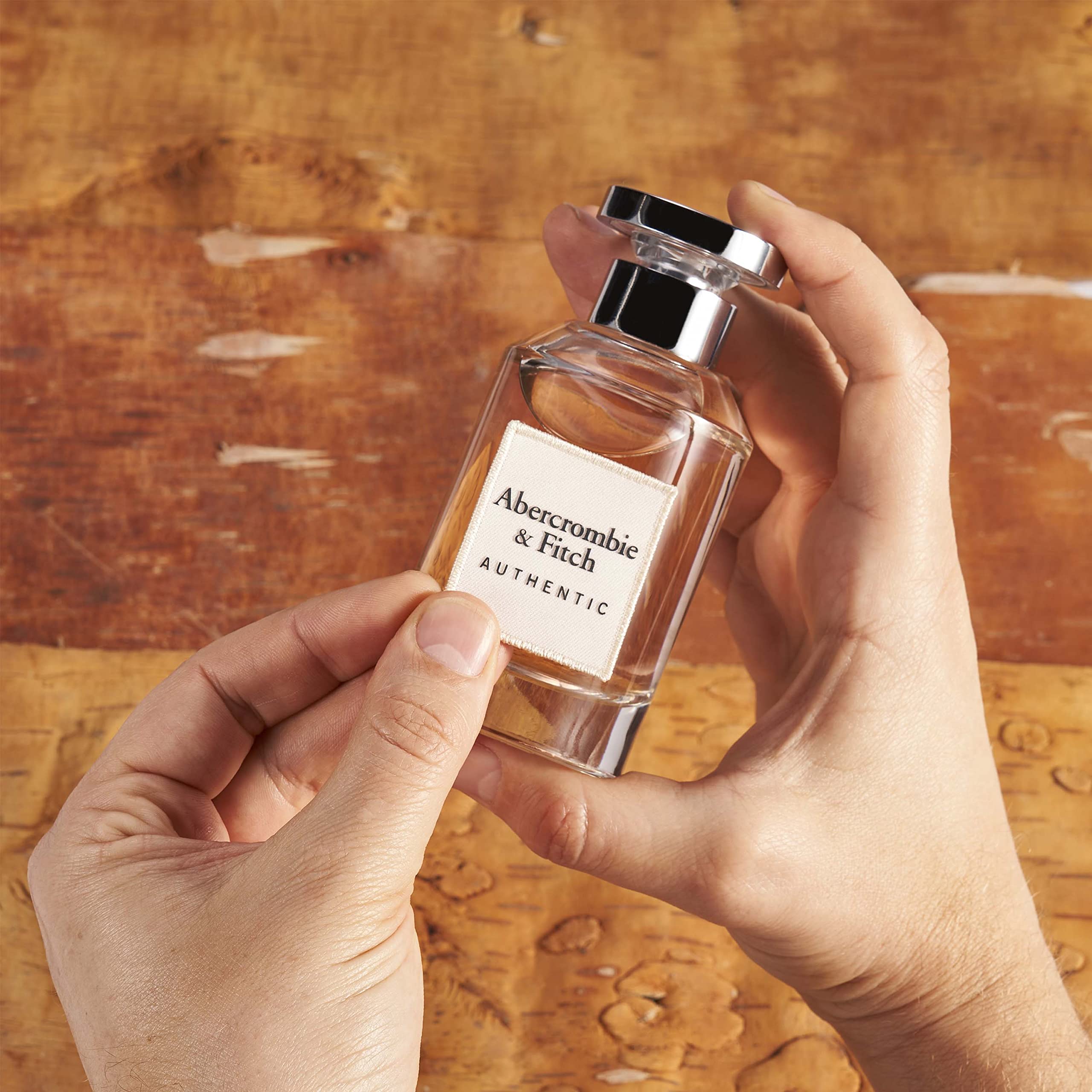 Abercrombie & Fitch Authentic Women bottle being poured, suggesting easy on-the-go refreshment.