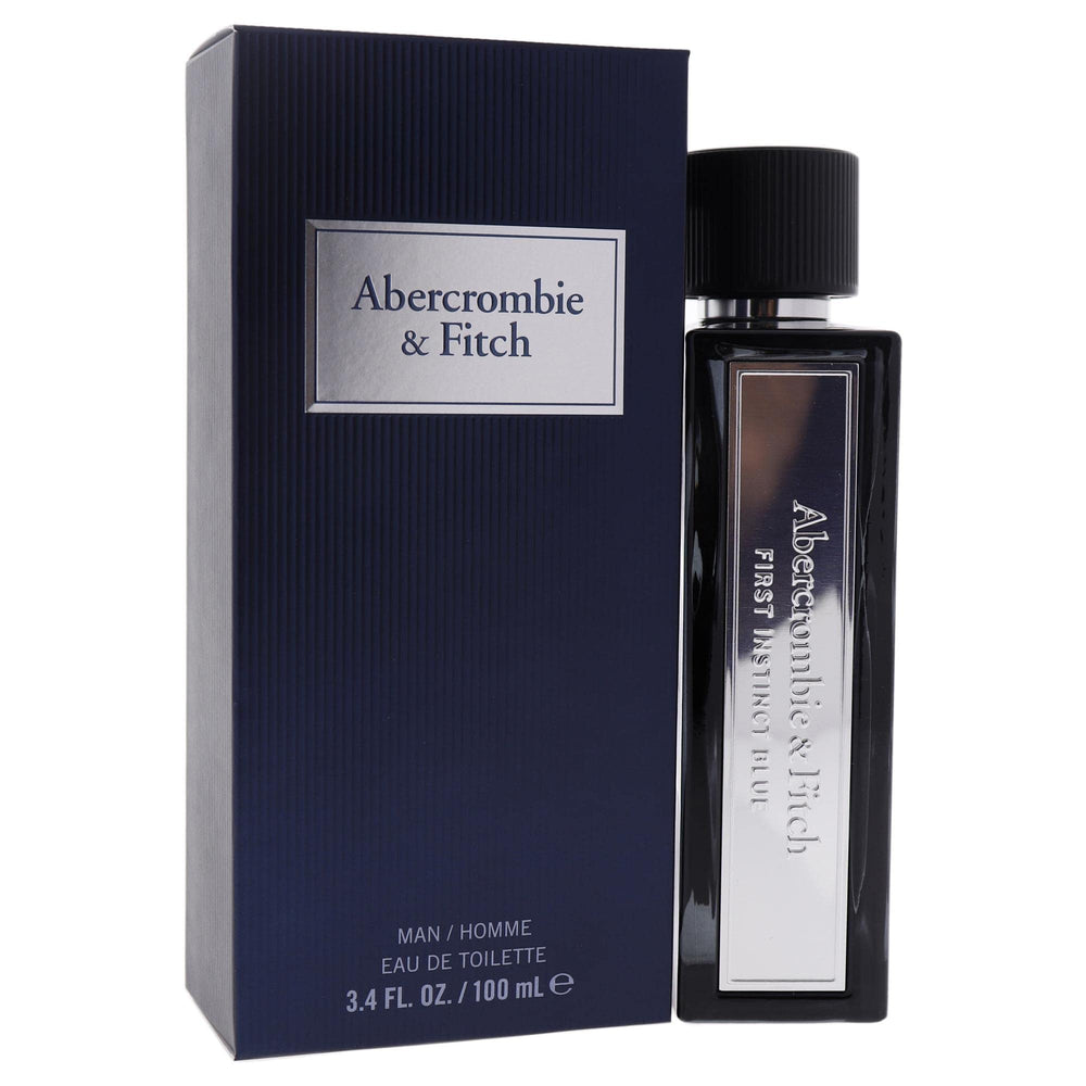 First Instinct Blue glass bottle under soft lighting communicates premium masculine scent.