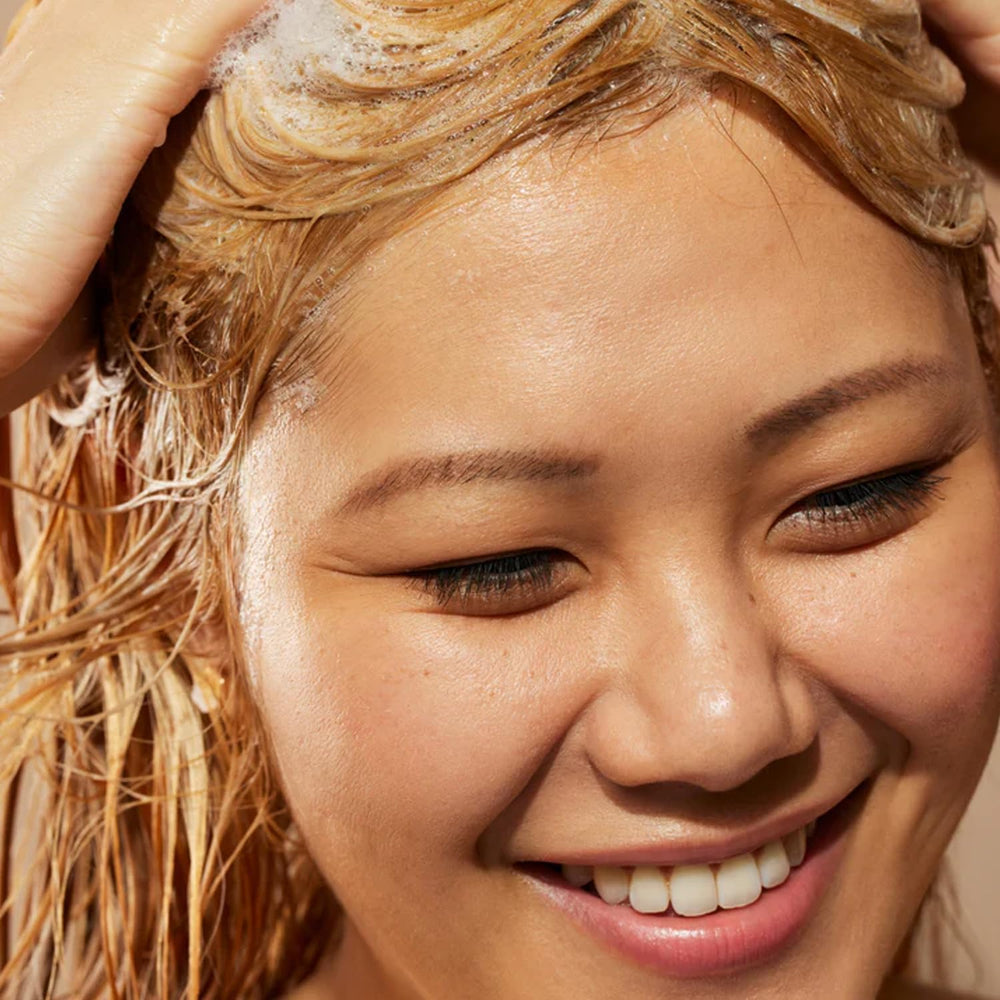 Acure Simply Smoothing coconut water image emphasizes refreshing hydration without weighing hair down.