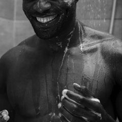 Aesop Classic Shampoo being applied to hair demonstrates cleansing during shower.