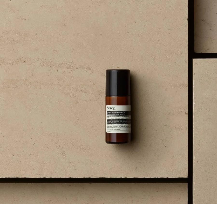 Aesop Herbal Deodorant Roll-On bottle close-up shows vegan packaging and recycled-content.