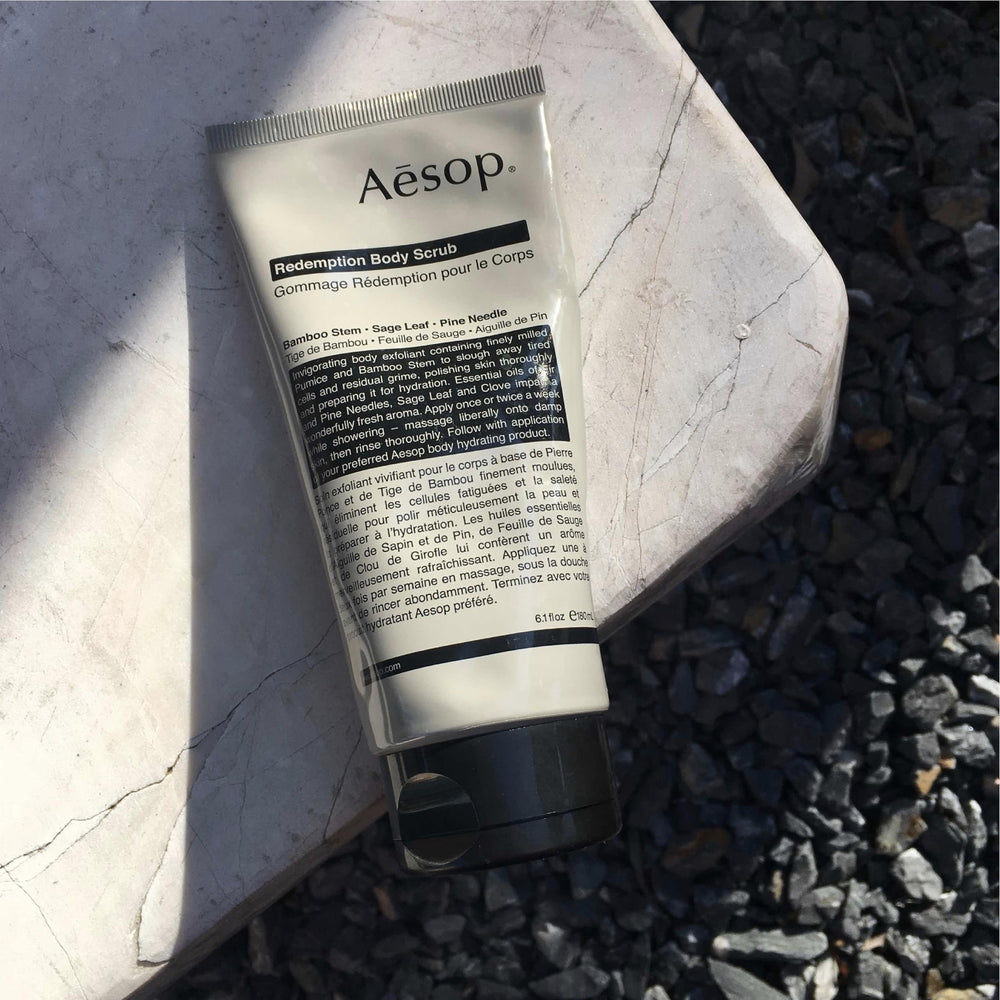 Aesop Redemption Body Scrub highlights bamboo, sage, and pine ingredients for a refined ritual.