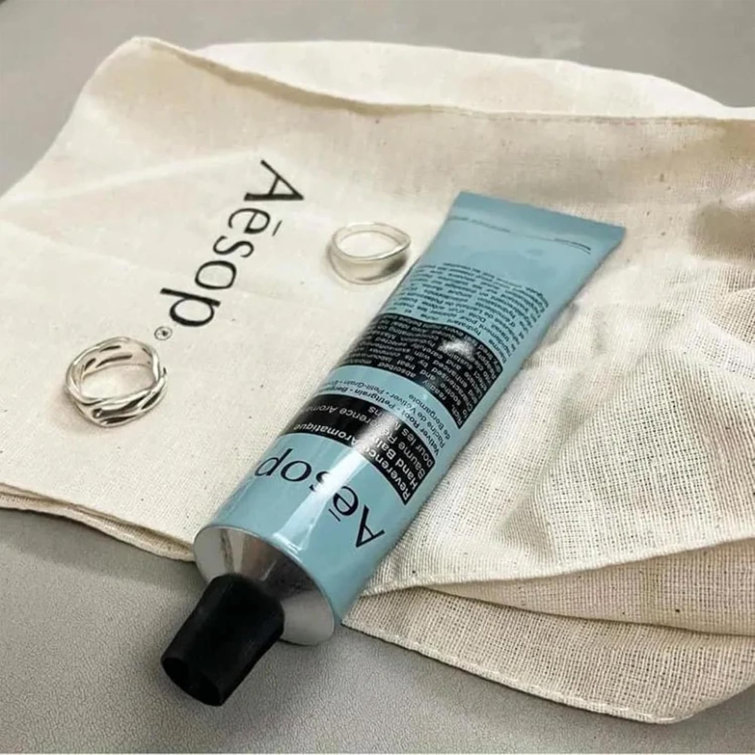 Aesop Reverence hand balm bergamot-vetiver-petitgrain close-up highlights botanical ingredients.