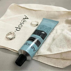 Aesop Reverence hand balm bergamot-vetiver-petitgrain close-up highlights botanical ingredients.