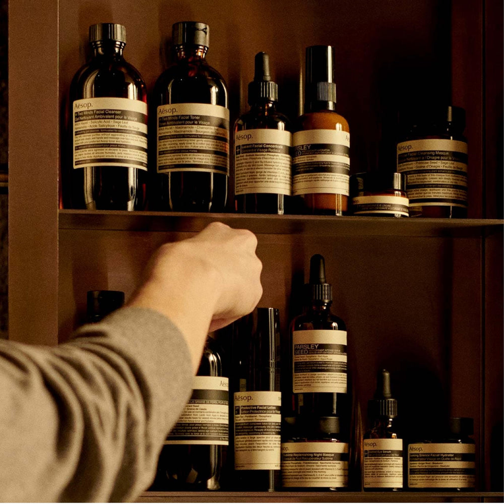 Aesop Rind Concentrate Body Balm with pink grapefruit ingredient close-up for citrus nourishment.