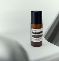 Aesop Roll On Deodorant used underarm, delivers fresh woody scent without harsh alcohol.