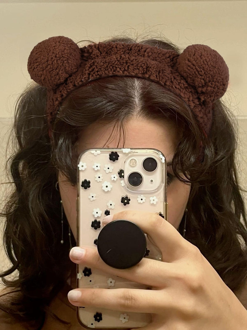AIBFRID brown bear headband holds hair during cleansing and mask application.
