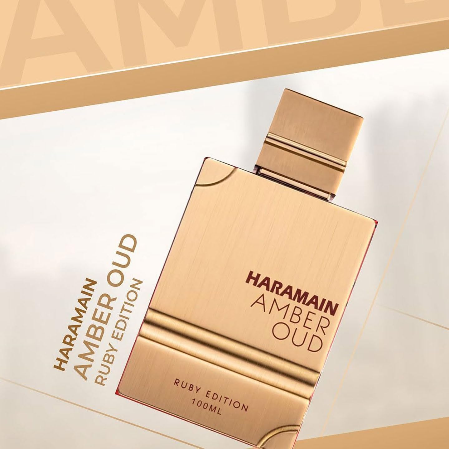 Al Haramain Amber Oud Ruby Edition close-up shows ornate logo detail for premium branding.