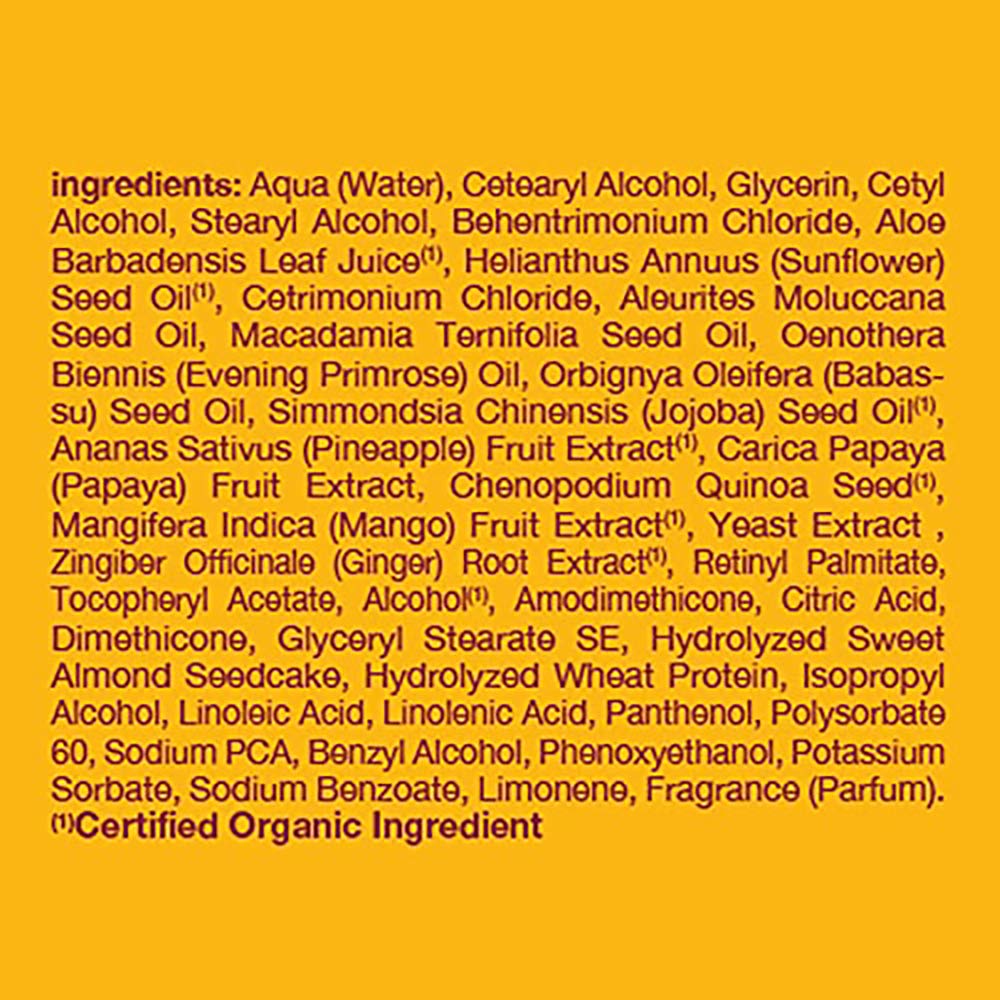 Alba Botanica Body Builder Mango conditioner bottle beside ripe mango fruit