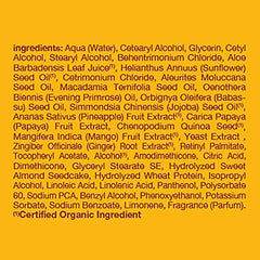 Alba Botanica Body Builder Mango conditioner bottle beside ripe mango fruit