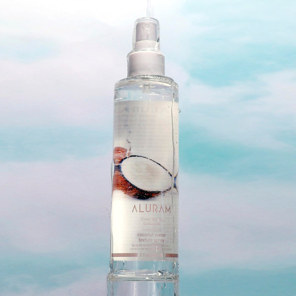 ALURAM Coconut Water Texture Spray on damp hair for hydrated, defined waves.