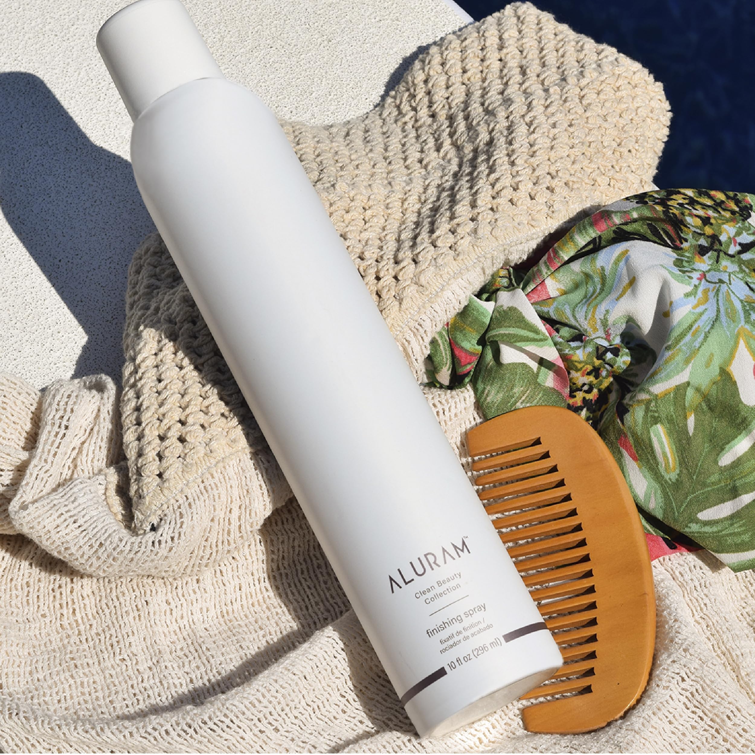 ALURAM finishing spray in hand mid-apply demonstrates buildable control for soft-to-firm styles.