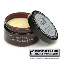 American Crew grooming cream being applied to towel-dried hair for style.