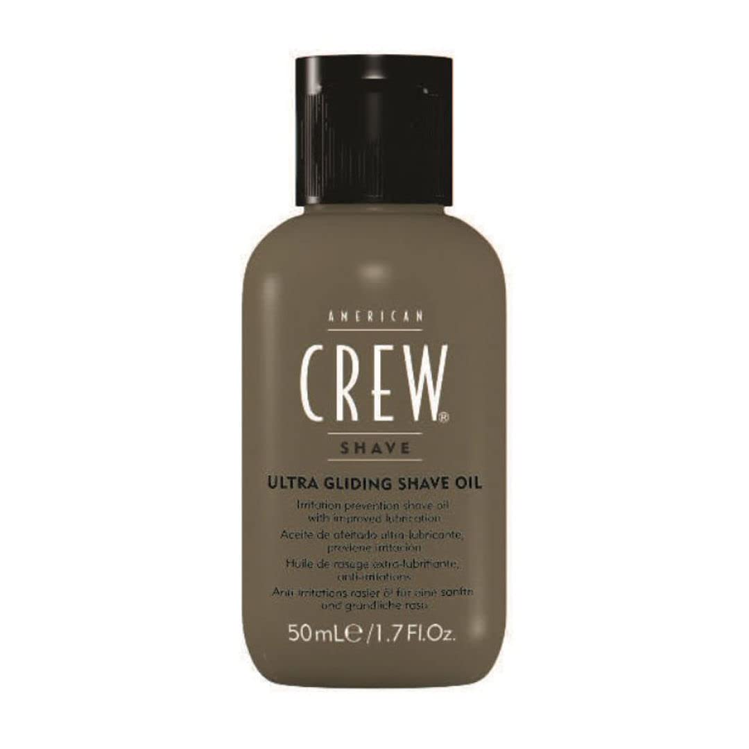 American Crew shave oil being poured for easy application.