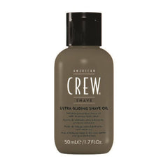 American Crew shave oil being poured for easy application.