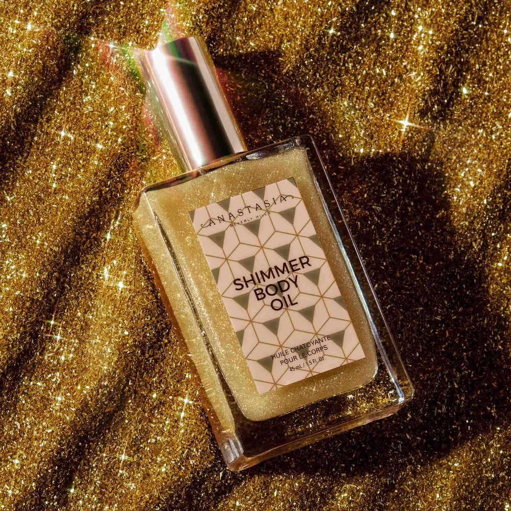 Anastasia Beverly Hills Shimmer Body Oil Gold bottle being shaken for easy application