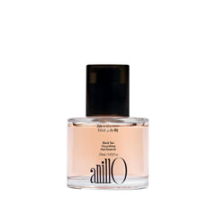 ANILLO Black Tea Nourishing Hair Essence bottle promises lightweight nourishment and silky shine.