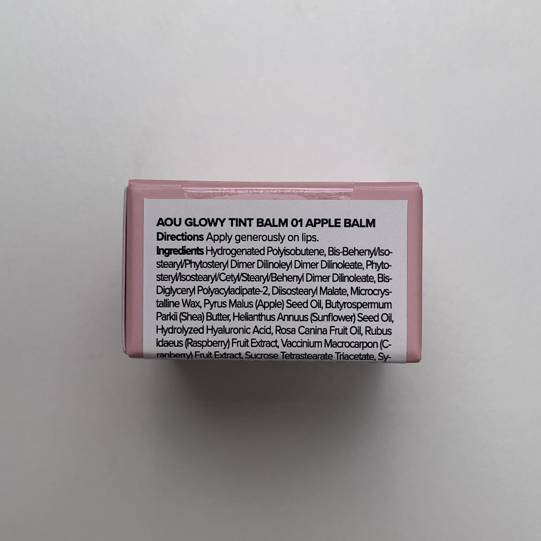 Applying AOU Glowy Tint Balm with melting texture for smooth lip glide