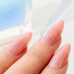 APRÉS Apres Light & Shadow Cuticle Serum applying to fingers—quick absorption with no greasy residue.