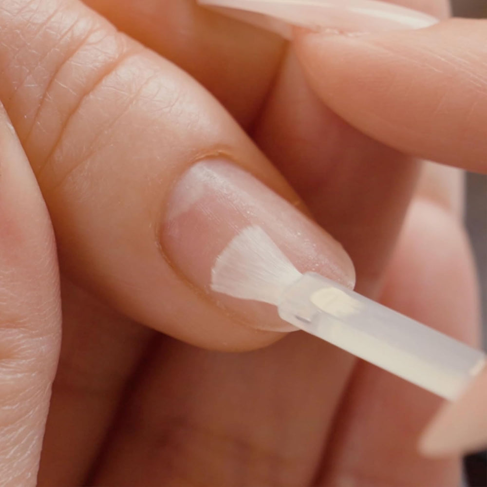 APRÉS primer brushed onto nail during manicure for even base.