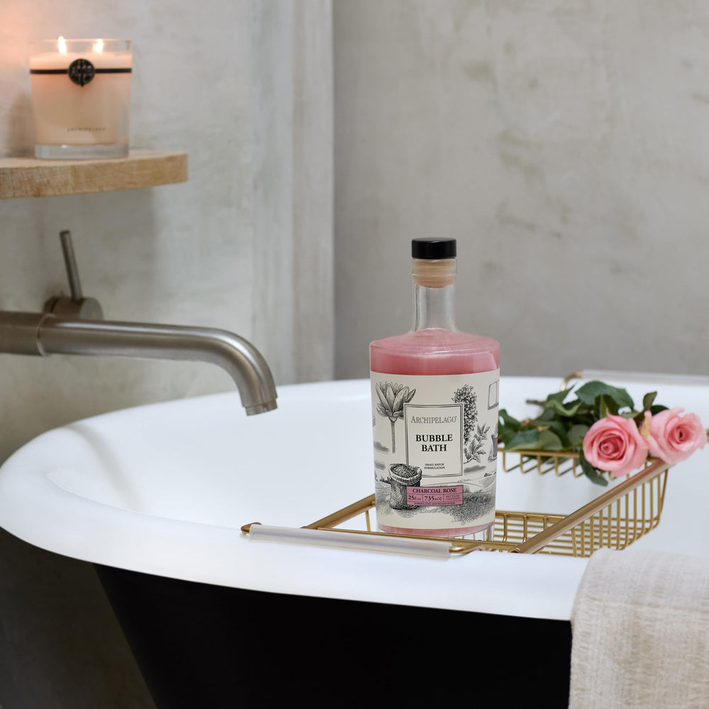 Archipelago Botanicals charcoal-rose-bath-foam-pour illustrating creamy lather for spa-like experience.