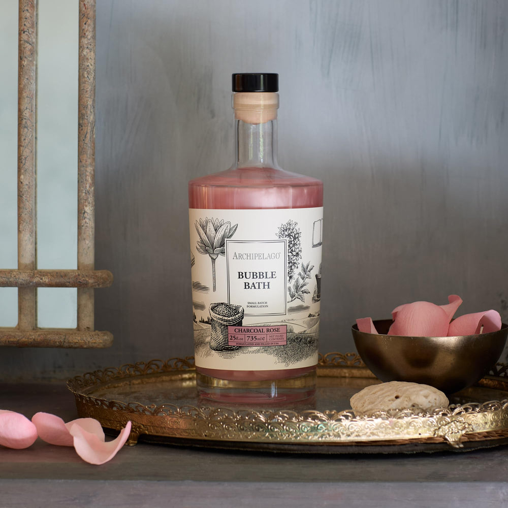 Archipelago Botanicals charcoal-rose-bath-rose-essence bottle highlights rose hydration ritual.