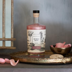 Archipelago Botanicals charcoal-rose-bath-rose-essence bottle highlights rose hydration ritual.