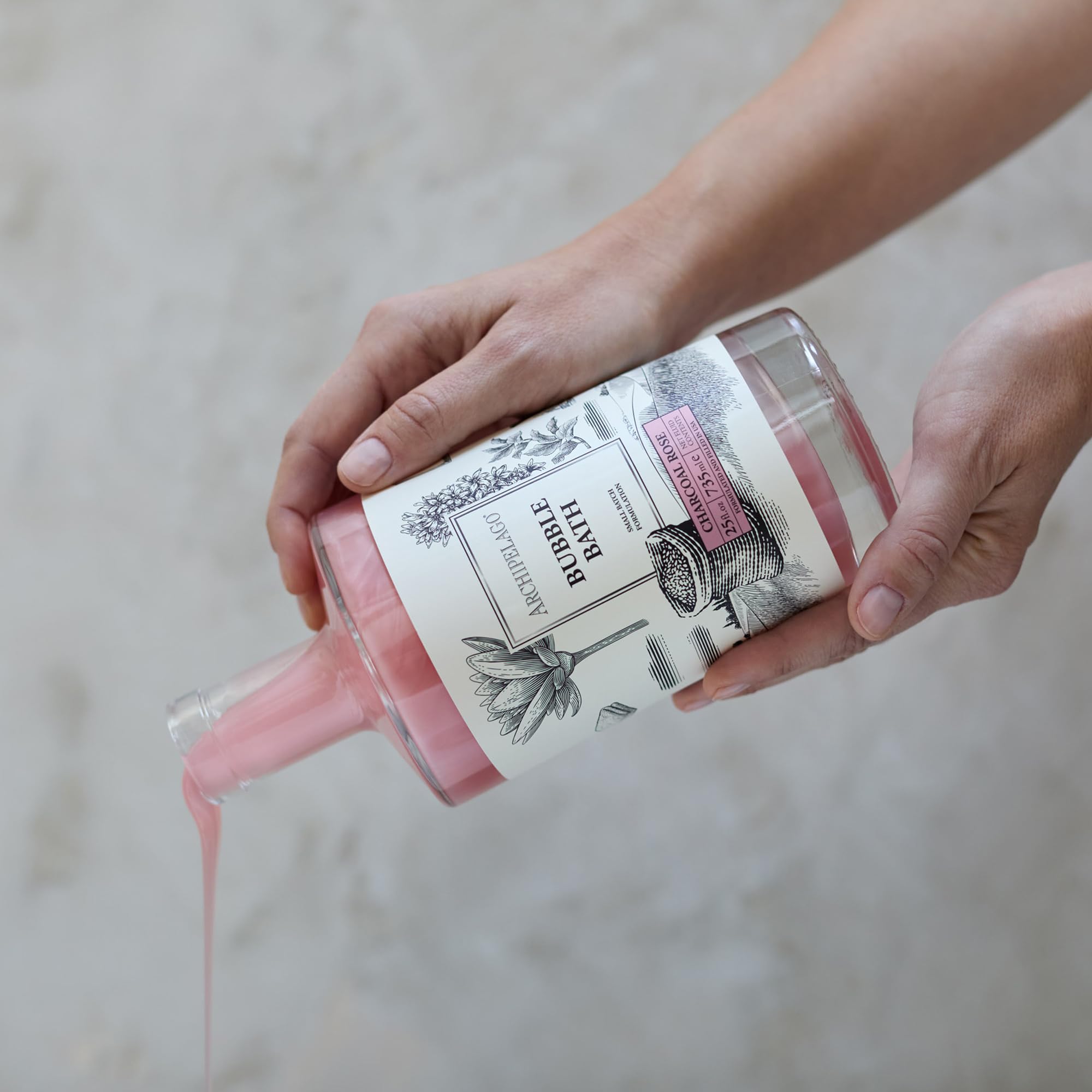 Archipelago Botanicals charcoal-rose-bath-water-stream demonstrating detoxifying soak effect.