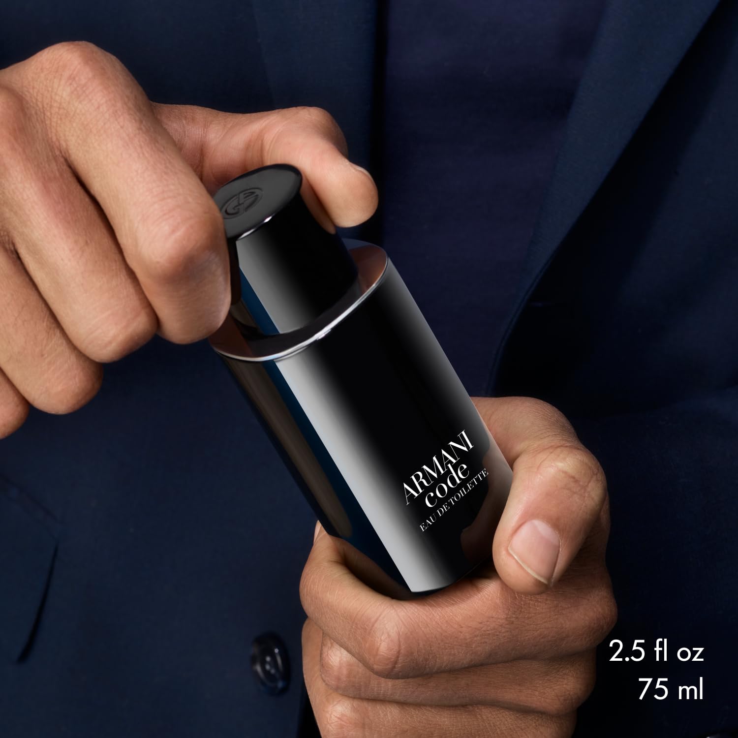 Armani Code refill bottle in hand, easy at-home replenishment option.