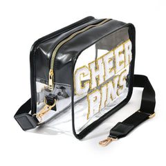 Ashpin Cheer Pins Bag side-straps shows adjustable strap for crossbody or clutch wear.