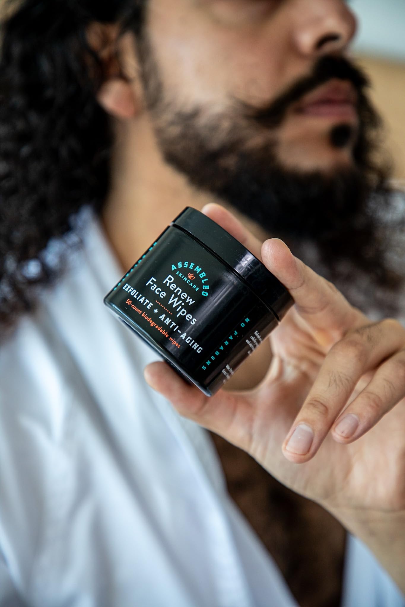 Assembled Renew Face Wipes in hand ready for oil-control cleansing and exfoliation.