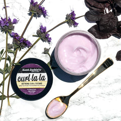 Aunt Jackie’s Curl La La texture on hair provides defined coils.