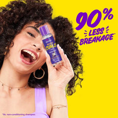 Aussie Miracle Curls Defining Oil being applied to damp curls to reduce frizz.