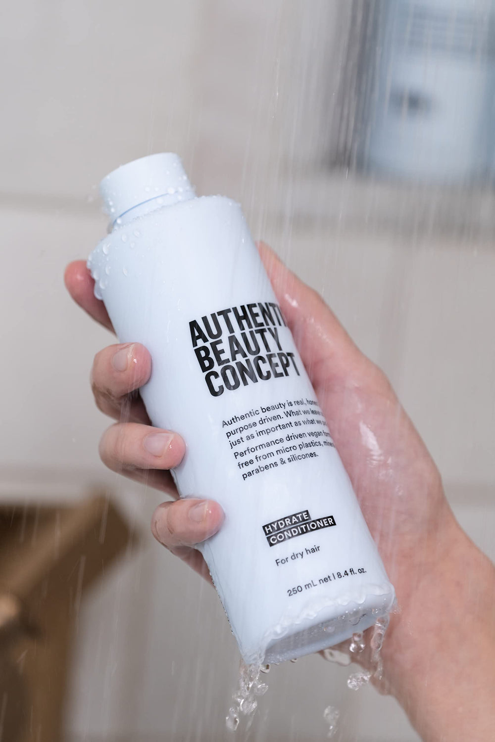 Hydrate Conditioner on a bathroom shelf suggesting daily-use moisture for hair
